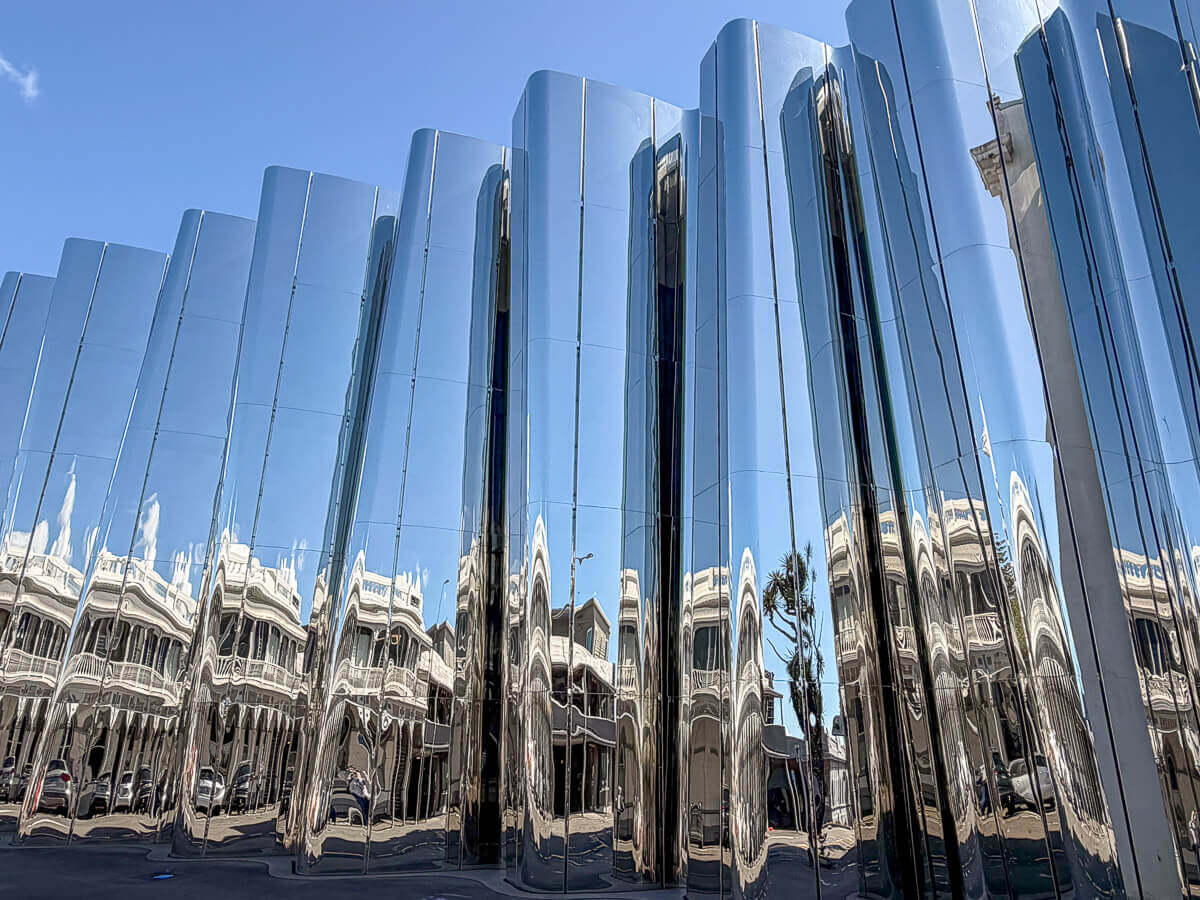 Neuseeland: Reisetipps für Mount Taranaki und New Plymouth 19 Edelstahlfassade eines Museums, in der sich die gegenüberliegenden Häuser aus der Pionierzeit spiegeln
