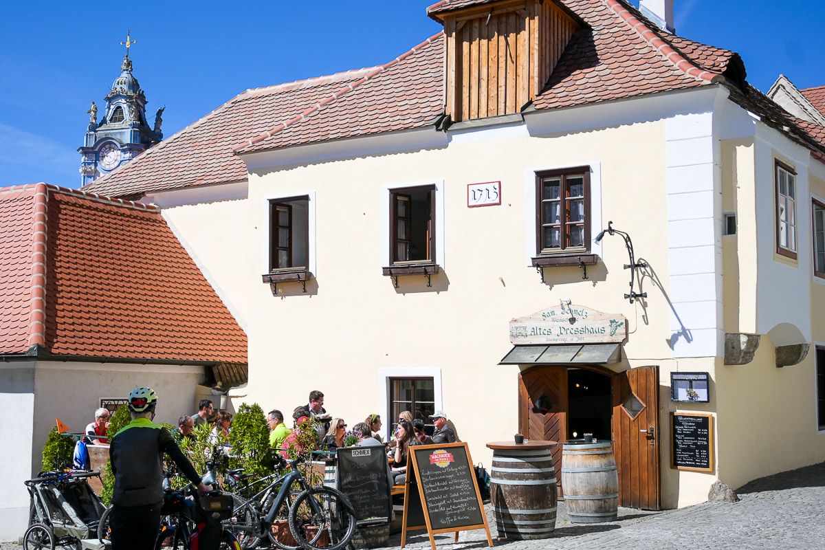 Weinschenke mit Gästen auf der Terrasse