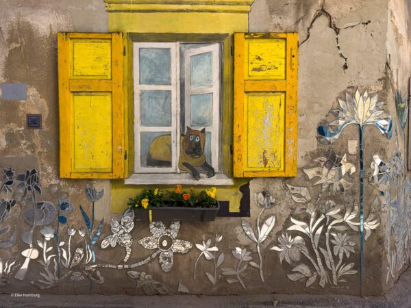 Wandbild, das ein Fenster mit Katze zeigt