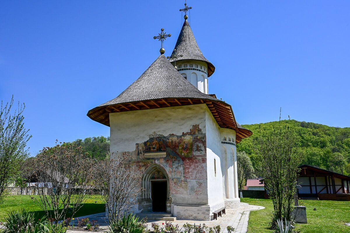 Faszinierende Bilderbibeln: Klöster in der Bukowina 38 Kleine Klosterkirche auf einer Wiese mit teilweise erhaltenem Fresko am Portal